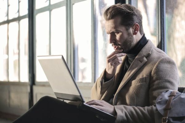 man looking confused at laptop